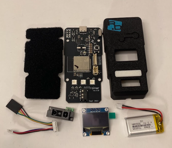 DTT build kit with PCB, housing, screen, sensor, battery, harness, velcro, and screws