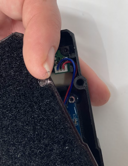 Wires routed around the peg inside the trainer housing